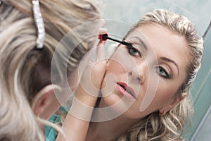 Woman doing make-up photo