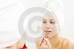Woman doing make-up after shower