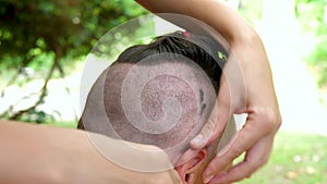 Woman Doing Man`s Hair With Cutting Machine