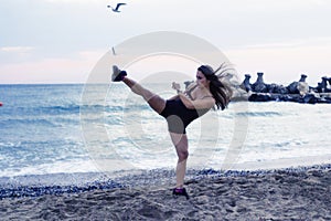 Woman doing martial arts at the beach