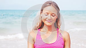 Woman doing meditation near the ocean beach. Yoga silhouette.