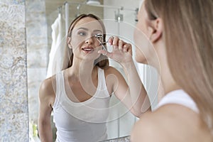 Woman doing morning rutine at bathroom