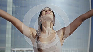 Woman doing namaste yoga pose on street. Lady practicing yoga on city street