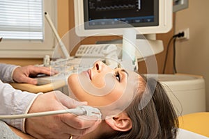 Woman doing neck ultrasound examination