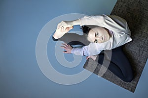 Woman doing Parivritta Kraunchasana, Revolved Heron, Compass Pose