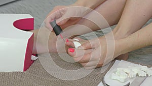 Woman doing pedicure and keeping foot inside UV lamp
