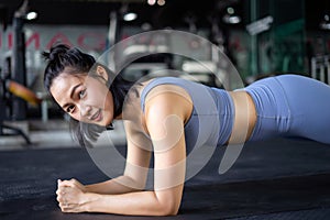 woman doing plank exercise on mat in gym. woman exercise trainer. lady sport.