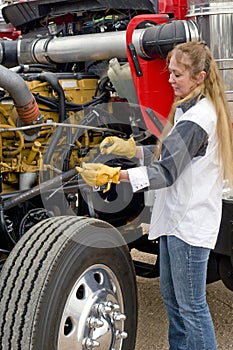 Woman doing pre-trip inspection.