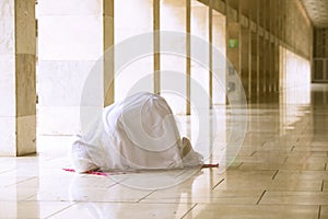 Woman doing prostration in mosque photo