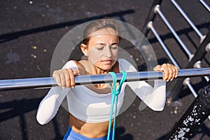 Woman doing pull-up. Strong girl in sportswear doing pull up exercise. Be H3althy.