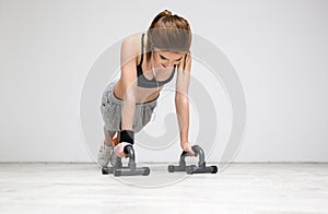 Woman doing push ups at gym