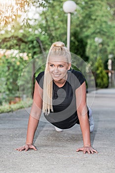 Woman doing push-ups outdoors