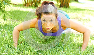 Woman Doing Push Ups In Park