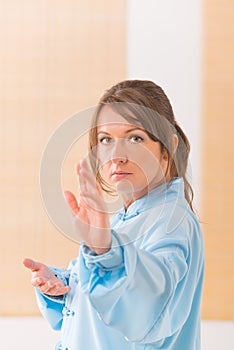 Woman doing qi gong tai chi exercise