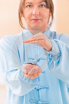 Woman doing qi gong tai chi exercise