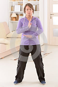 Woman doing qi gong tai chi exercise