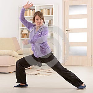 Woman doing qi gong tai chi exercise