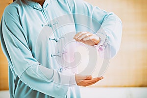 Woman doing qi gong tai chi exercise