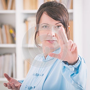 Woman doing qi gong tai chi exercise