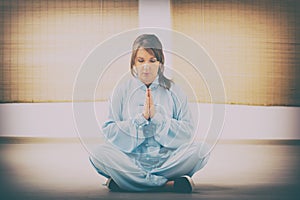 Woman doing qi gong tai chi exercise photo