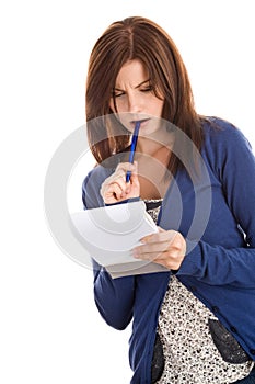 Woman doing records biting pen