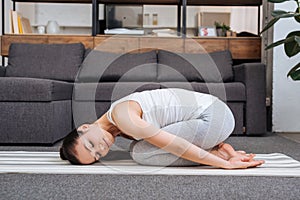 Woman doing relaxation exercise at home in