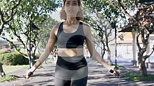 Woman doing rope skipping in the park