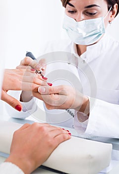 Woman doing shellac manicure
