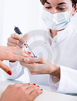 Woman doing shellac manicure