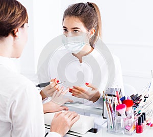 Woman doing shellac manicure