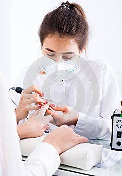 Woman doing shellac manicure