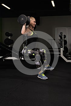 Woman Doing Shoulders Exercise With Dumbbells