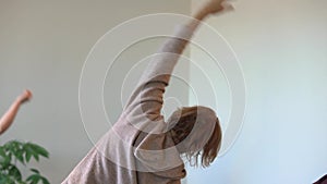 Woman doing side bend with hand rotation