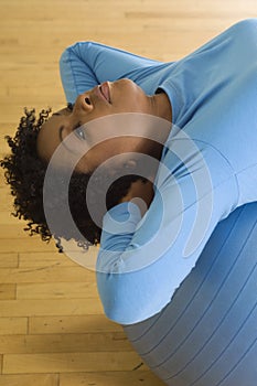 Woman Doing Sit-Ups On A Pilates Ball