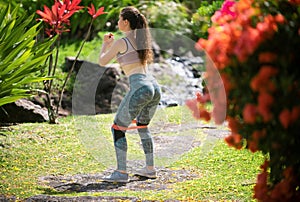 Woman doing sports outdoors. Female fit back and buttocks.