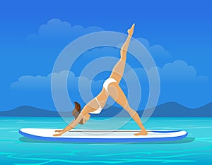 Woman doing Stand Up Paddling Yoga on Paddle Board. SUP yoga workout
