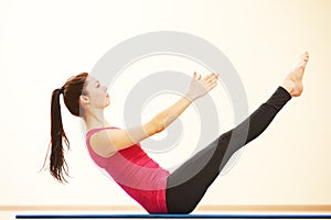 Woman doing stretching excercises in gym