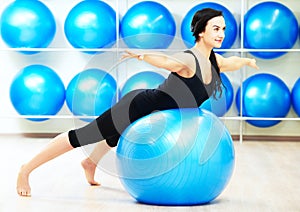 Woman doing stretching on fitness ball