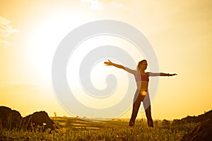 Woman Doing Stretching Outdoor. Warm up Exercise Against Sunset. Sport and Healthy Active Lifesyle Concept.