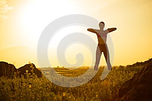 Woman Doing Stretching Outdoor. Warm up Exercise Against Sunset. Sport and Healthy Active Lifesyle Concept. photo