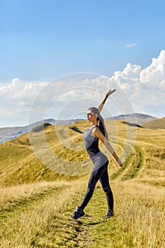 Woman Doing Stretching Outdoor. Warm up Exercise in the Hot Summer Evening. Sport and Healthy Active Lifesyle Concept