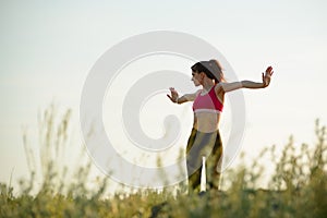 Woman Doing Stretching Outdoor. Warm up Exercise in the Summer Evening. Sport and Healthy Active Lifesyle Concept.