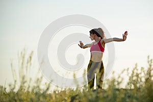 Woman Doing Stretching Outdoor. Warm up Exercise in the Summer Evening. Sport and Healthy Active Lifesyle Concept. photo