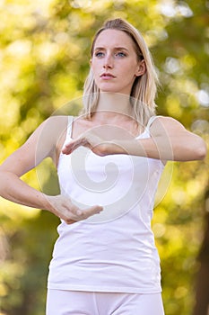 Woman doing tai chi in park