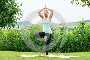 Woman doing tree vrksasana yoga pose
