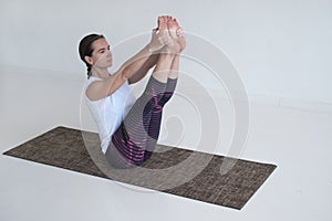 Woman doing Ubhaya Padangusthasana asana, Both Big Toe pose from yoga photo