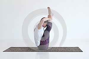 Woman doing Ubhaya Padangusthasana asana, Both Big Toe pose from yoga photo