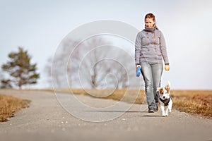 Woman is doing a walk with her puppy dog