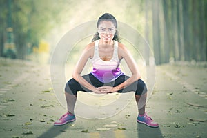 Woman doing warm-up before jogging at park