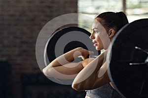 Woman doing weight lifting at cross fit gym